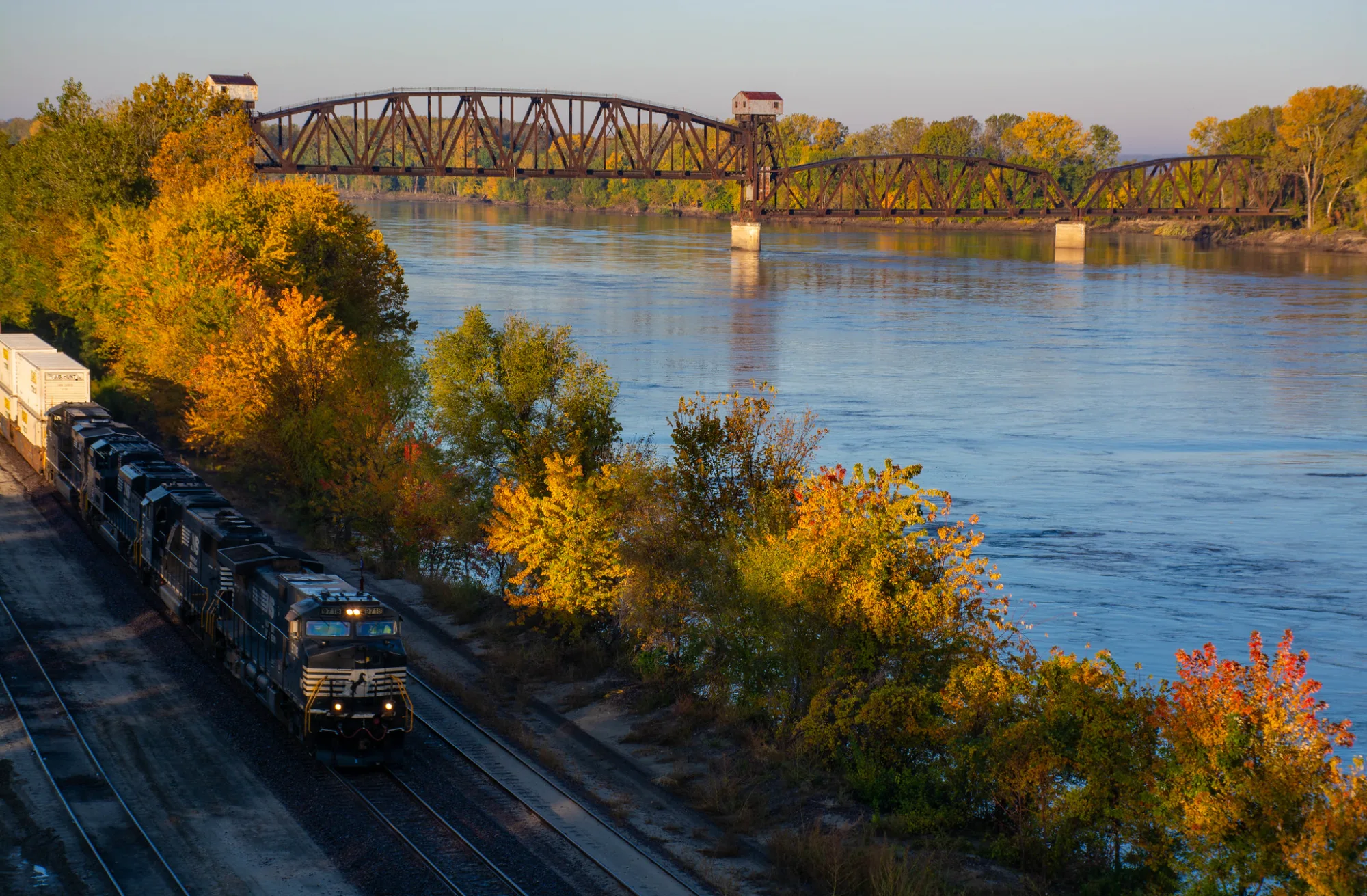 The Boonville Katy lift bridge over the Missouri River on an autumn morning, freight train on the near bank